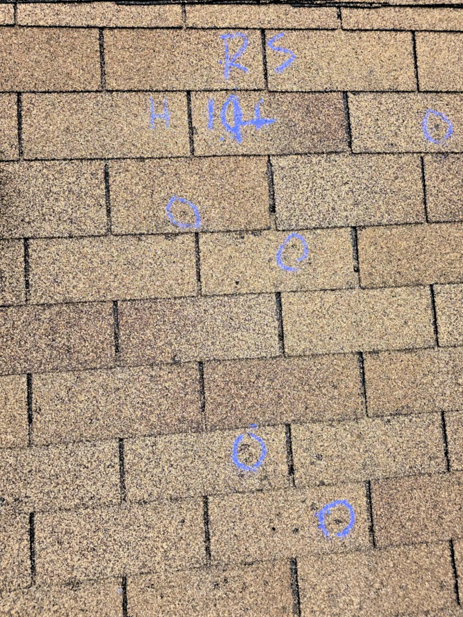 Hail damage marked on roof shingles